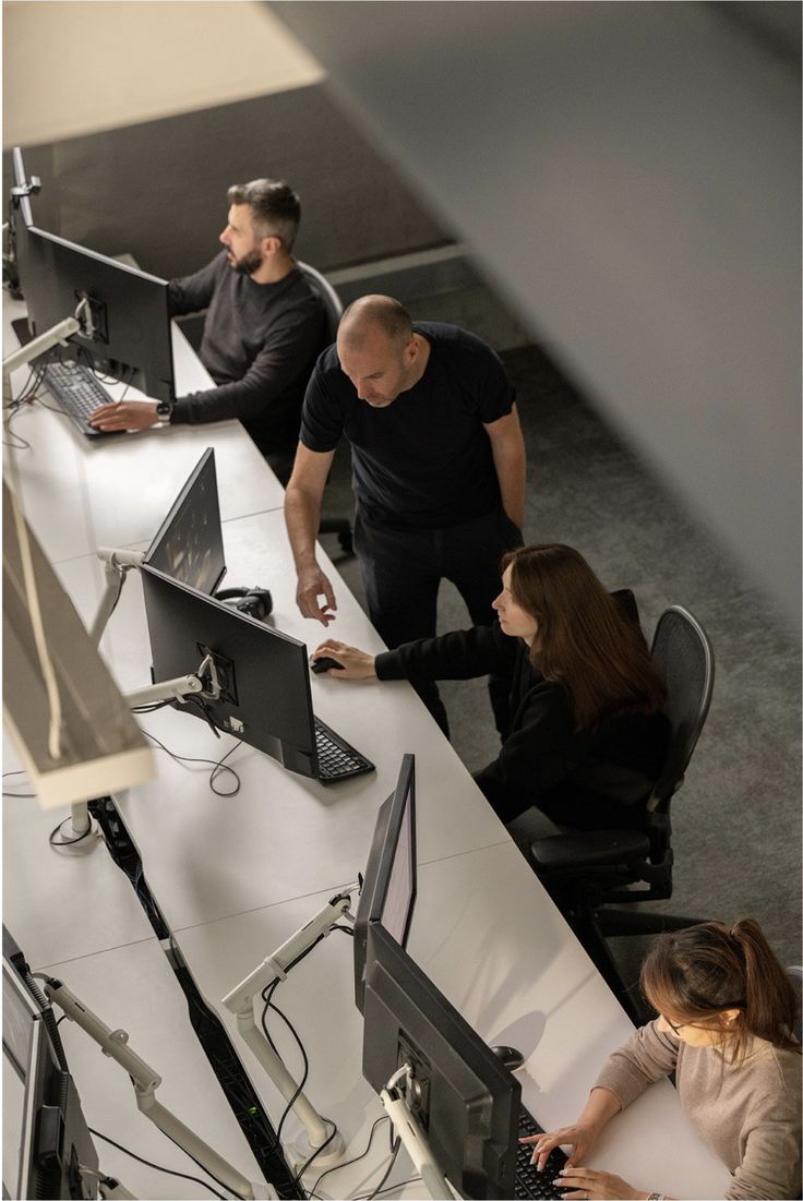 NovaBridge-teamet går igenom ett arbete tillsammans vid skärmarna